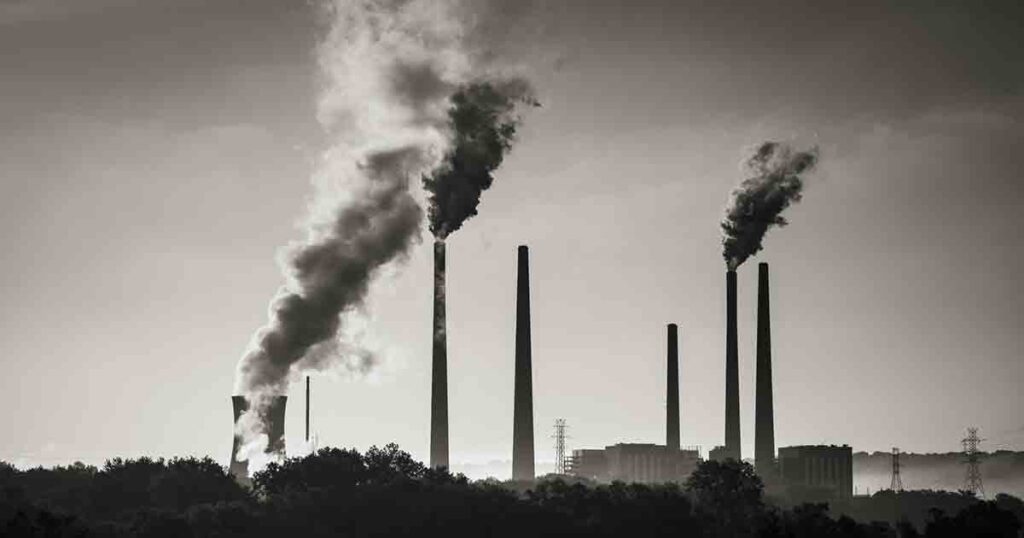 Image of a coal fired power plant on the Ohio River with pollution being released into the atmosphere