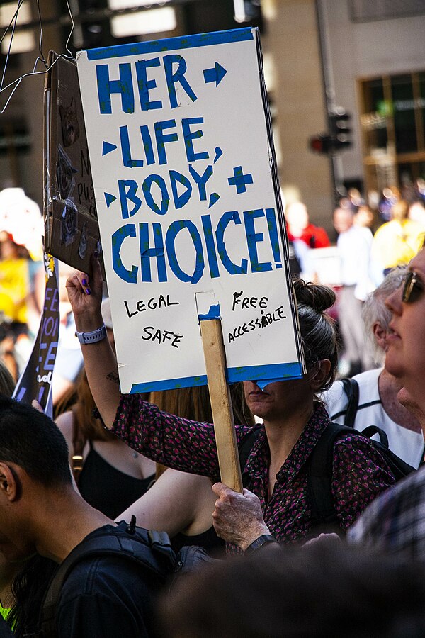 Protester holding sign that reads, "her life, body, and choice" during the Rally for Reproductive Rights in Chicago