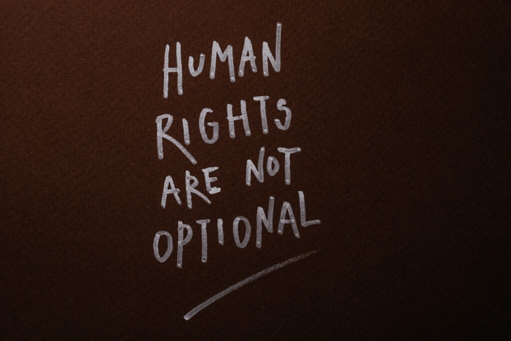 Black wall with words written in white: human rights are not optional